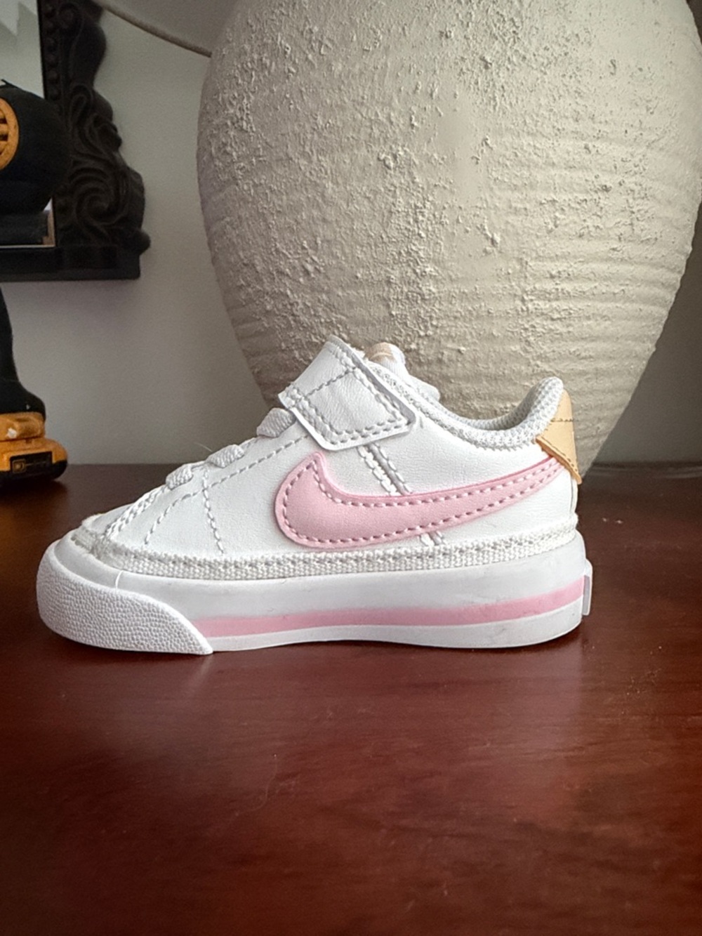 Nike Kids White Sneaker with Pink Swoosh and Pink Midsole Stripe. 3C